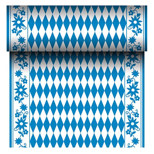 The PAPSTAR Airlaid table runner "Bayrisch Blau" (24 m x 40 cm) from PAPSTAR GmbH is a fabric-like table runner with a blue and white diamond center and a blue floral border. The roll reveals its repeating Bavarian pattern as it unrolls.