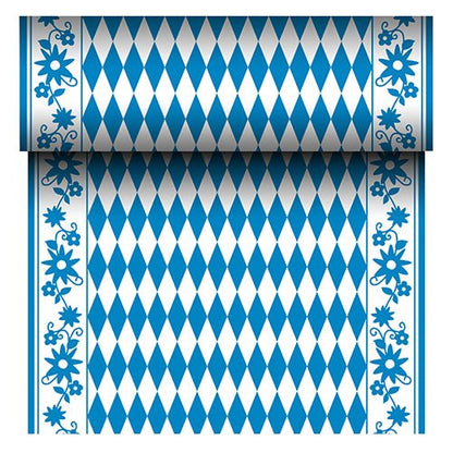 The PAPSTAR Airlaid table runner "Bayrisch Blau" (24 m x 40 cm) from PAPSTAR GmbH is a fabric-like table runner with a blue and white diamond center and a blue floral border. The roll reveals its repeating Bavarian pattern as it unrolls.
