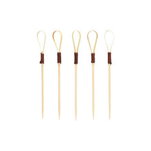 Forty PAPSTAR finger food picks 10 cm "Loop" cocktail picks from PAPSTAR GmbH, ideal for snacks and finger food, feature a unique loop design with dark brown wrapped sections arranged upright against a plain white background.