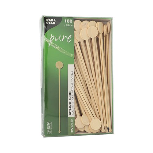 A box with 100 PAPSTAR GmbH "pure" bamboo drink stirrers, biodegradable, with round flat ends, partially visible through a window in green and white PAPSTAR Pure packaging.