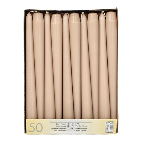 A box with Starpak 50 taper candles (Ø 2.2 cm - 25 cm), arranged upright in a row, with a bottom label stating "50 pieces", multilingual text, and a note on the long burning time.