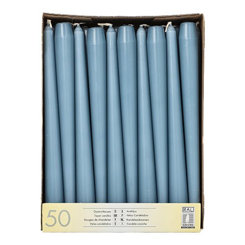 A cardboard box with 50 Starpak taper candles (Ø 2.2 cm - 25 cm), arranged upright in rows, with a label on the front showing the technical data and the long burn time for extended use.