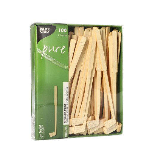 A green box with the inscription "PAPSTAR 100 drink stirrers, bamboo "pure" from PAPSTAR GmbH contains 100 environmentally friendly bamboo stir sticks (approx. 15 cm), partially visible through a window. The box is adorned with white text and a leaf graphic.