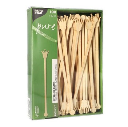 A pack of 100 PAPSTAR 20cm drink stirrers made from biodegradable bamboo, crown-shaped, partially visible through the window. The packaging bears the logo of PAPSTAR GmbH.