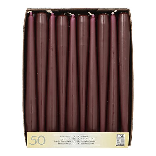 A box with 50 Starpak taper candles (Ø 2.2 cm, 25 cm long), arranged upright in rows, with a label on the front showing "50" and multiple translations for taper candle.