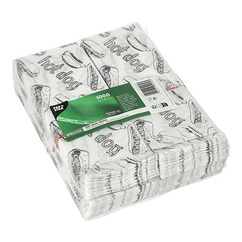 The 1000 PAPSTAR hot dog bags (21x8.5 cm, white) from PAPSTAR GmbH are shrink-wrapped and feature a black hot dog graphic and the "Hot Dog" lettering. A green label with product information is attached.