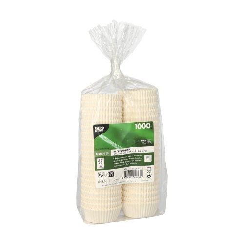 In a clear plastic bag, there is a stack of 1,000 PAPSTAR 1000 baking cups round of PAPSTAR GmbH, equipped with a green-white central label with product details.