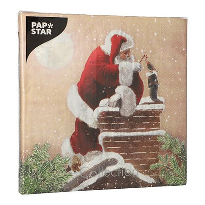 PAPSTAR 20 napkins, 40x40 cm, 3-ply, with Christmas motif: Santa Claus puts a candy cane in a stocking on a snow-covered chimney, fir branches and moon in the background. PAPSTAR GmbH branding top left.