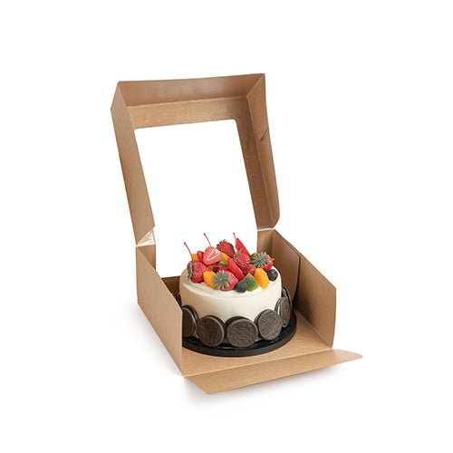 A small round cake with various fruits is presented in an open PAPSTAR 25 cake boxes with lids rectangular with PLA window from PAPSTAR GmbH against a white background.