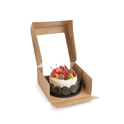 A small round cake with various fruits is presented in an open PAPSTAR 25 cake boxes with lids rectangular with PLA window from PAPSTAR GmbH against a white background.