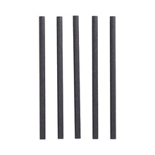 Five black cylindrical PAPSTAR 100 shake straws paper Ø 10 mm · 21 cm from PAPSTAR GmbH stand upright in a row against a white background - ideal for environmentally conscious hosts.