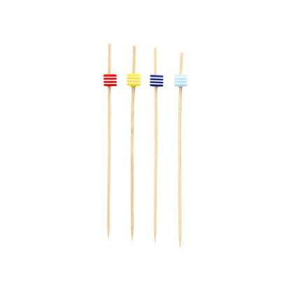Four "PAPSTAR 100 Fingerfood - Picks" from PAPSTAR GmbH stand vertically on a white background. Each pick has a small, rectangular bead near the tip in red, yellow, blue, or light blue.