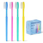 Four disposable toothbrushes in blue, pink, green, and yellow stand upright next to a blue ARNOMED disposable toothbrush with toothpaste box (100 pieces) from ARNOWA GmbH - each toothbrush individually packed with toothpaste.