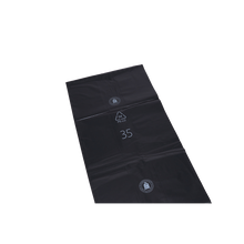 Flat, rectangular DEISS 95076 garbage bags from EMIL DEISS KG (GmbH + Co.) made of sturdy black plastic, printed with white symbols and the number 35, lie on a white background - ideal for commercial disposal.
