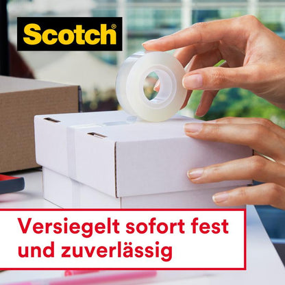 A person seals a white box with Scotch® Crystal Tape, transparent, 1 roll (19 mm x 33 m) by 3M Deutschland GmbH. The tape is applied by hand. The text reads "Seals instantly and reliably," the Scotch logo is visible.
