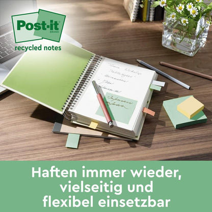 On a desk lie a spiral notebook with Post-it® Recycling Notes (38 mm x 51 mm, 100 sheets/block, 100% PEFC) from 3M Deutschland GmbH, scattered notes, a ballpoint pen, a pencil, and a vase with green stems. A German text is at the bottom.