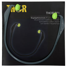 A pair of gray Abena Re-Seller GmbH Thor ear muffs (812010) with green foam tips rests on multilingual packaging labeled "Pack (15 pieces)."