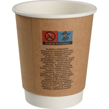The "Kraft" double-walled coffee cup from Abena Re-Seller GmbH is a brown-and-white disposable paper cup labeled with warning notices and the phrase "Plastic in Product" in several languages; stainless steel insulated cups offer a reusable alternative.