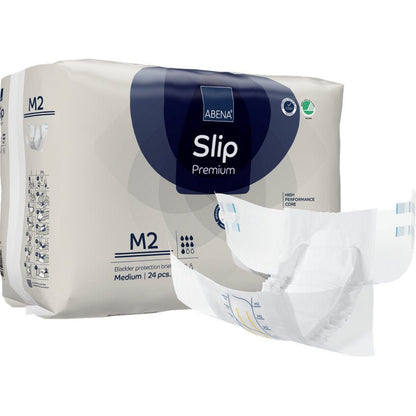 Behind an unfolded diaper is a pack of ABENA Slip Premium from Abena Re-Seller GmbH, size M2. The packaging indicates that it contains 24 medium-sized slips for reliable incontinence care.