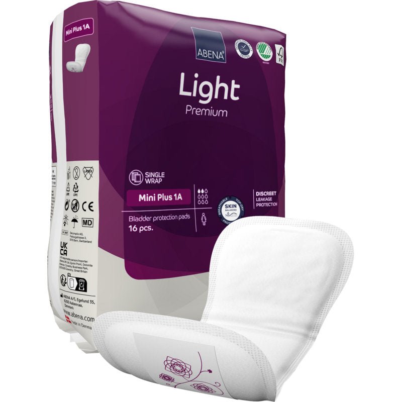 A pack of ABENA Light Mini Plus 1A, Premium by Abena Re-Seller GmbH (16 pieces) for light bladder weakness. An insert is depicted outside the pack. It has a curved, absorbent shape with a subtle floral print.