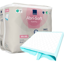 One package of Abena Re-Seller GmbH’s Abri-Soft Superdry disposable pads, 80x180 cm, contains 30 disposable pads. One pad is partially unfolded at the front. The packaging highlights the product’s key features—ideal for incontinence care.