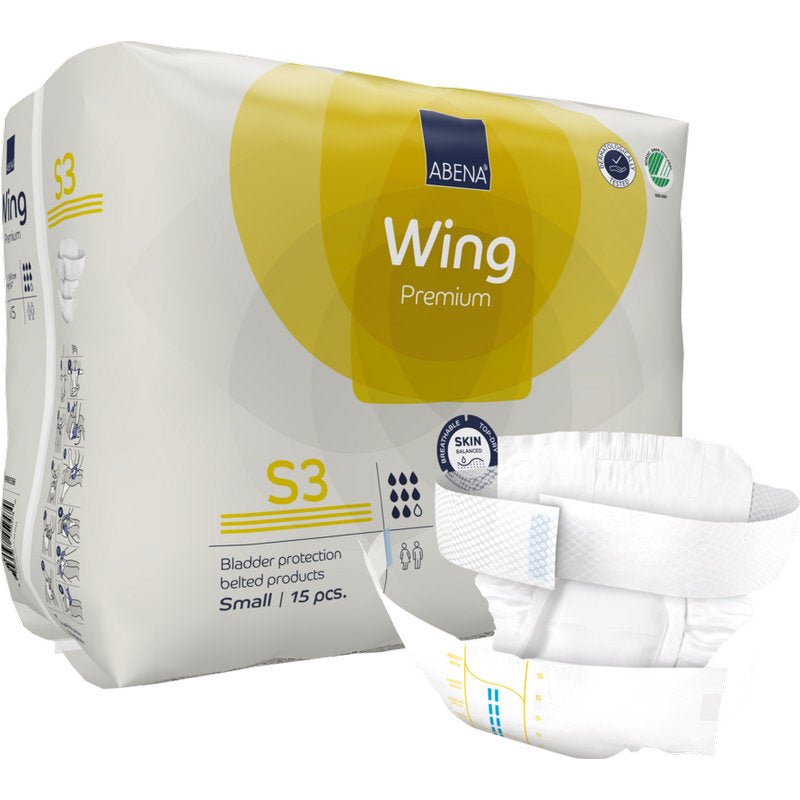 An upright standing package of ABENA Wing Premium by Abena Re-Seller GmbH is presented with a belt diaper in front. The package contains 15 small pieces that offer protection and comfort for reliable bladder protection.