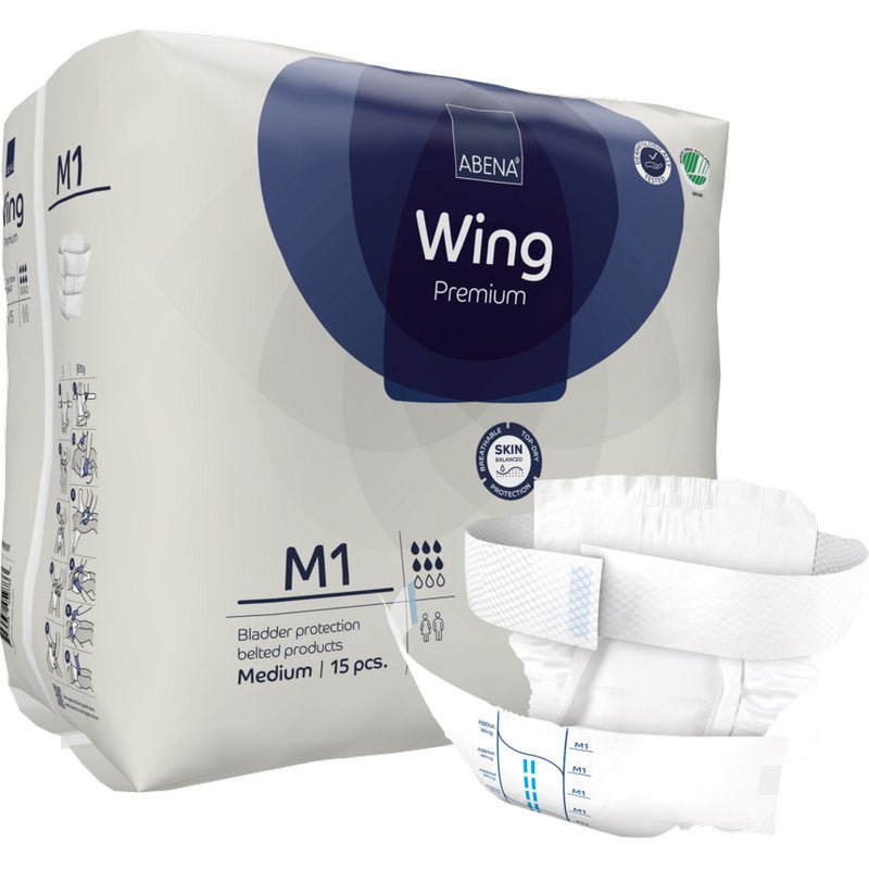 A package of Abena Re-Seller GmbH ABENA Wing Premium is shown with an unfolded pad on the front that offers protection and comfort. The packaging states that it contains 15 medium-sized pads for bladder protection.