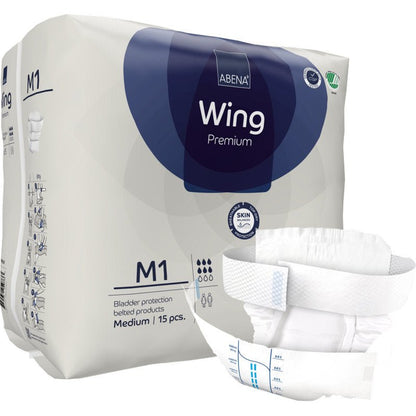 A package of Abena Re-Seller GmbH ABENA Wing Premium is shown with an unfolded pad on the front that offers protection and comfort. The packaging states that it contains 15 medium-sized pads for bladder protection.