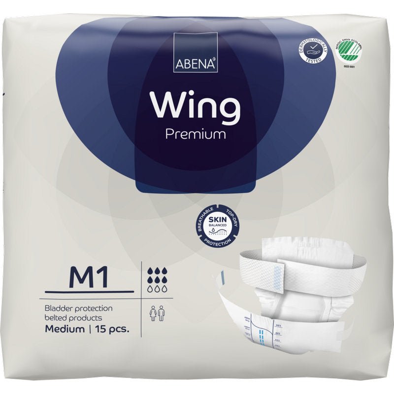 A 15-piece package of ABENA Wing Premium incontinence slips with belt, medium, by Abena Re-Seller GmbH. The white package with dark blue accents shows product symbols and an image of the slip for optimal protection and comfort.