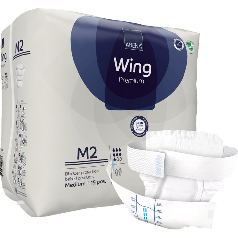 Shown is a package of Abena Re-Seller GmbH ABENA Wing Premium, containing 15 medium-sized incontinence products with a belt. A product is depicted on the front, highlighting ultimate protection for adults.