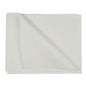 A disposable towel, airlaid, white from Abena Re-Seller GmbH lies on a white background, with one corner folded up to show the structure and thickness of the high-quality disposable fabric.