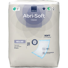 A package containing 60 Abena Re-Seller GmbH disposable pads, Abri-Soft Classic, 40x60 cm, blue. The predominantly white and light gray packaging highlights the softness, the waterproof pad, and the extra protection.