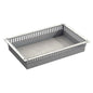 A gray, rectangular Novocal ABS module tray with ventilated sides, flat bottom, and evenly distributed vertical slots on the edge; with drawer stops and divisible.