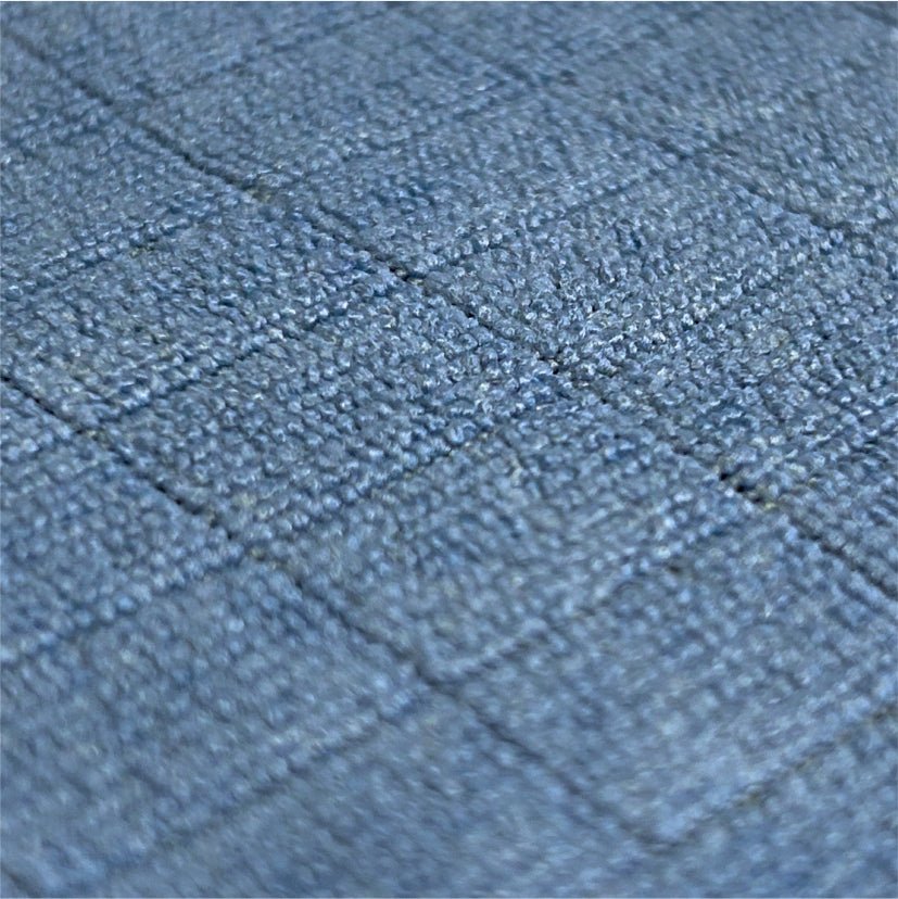 Close-up of the Arcora Floor-Clean microfiber floor cloth from Arcora International GmbH: a fabric surface with a grid of small, raised blue-gray squares, ideal for floor cleaning. The pack contains 10 pieces.