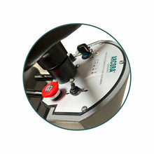 Close-up of the control panel of the Arcora Ro-Man 660Br/90L ride-on scrubber dryer from Arcora International GmbH with switches, indicator lights, and an emergency stop button on a metal surface.