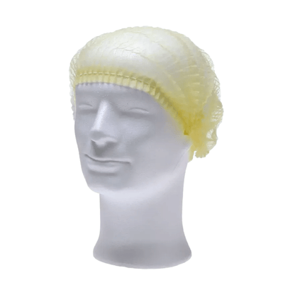 On a white mannequin head, an AMPri ECO-PLUS clip cap is visible, a light yellow disposable hair net for medical purposes. This food-safe accessory from AMPri Handelsgesellschaft mbH sits securely around the head and covers the top and sides, with the mannequin isolated against a plain white background.