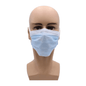 In front of a white background, there is a mannequin head wearing a light blue AMPri MED-COMFORT surgical mask for tying Type IIR from AMPri Handelsgesellschaft mbH. The mask covers the nose and mouth and offers optimal mouth and nose protection. It is fastened with ear loops. The mannequin has a light skin tone and is bald.