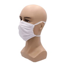 A mannequin head wears a white AMPri MED-COMFORT surgical mask for tying Type IIR from AMPri Handelsgesellschaft mbH, covering the nose and mouth. The medical mask is fastened with elastic bands around the ears. The mannequin is bald and has realistic facial features. The background is white.