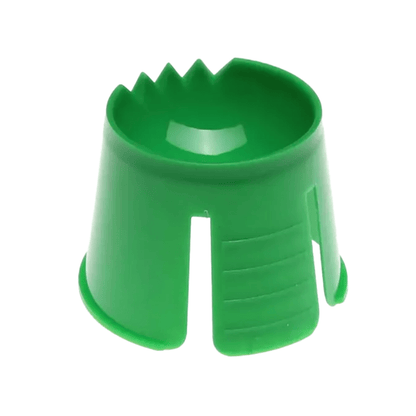 A green object made of AMPri polypropylene, resembling a conical cup with notches and slots at the upper edge, possibly used to secure or hold an item in place, serves as an ideal disposable dappen dish for mixing and portioning dental materials.