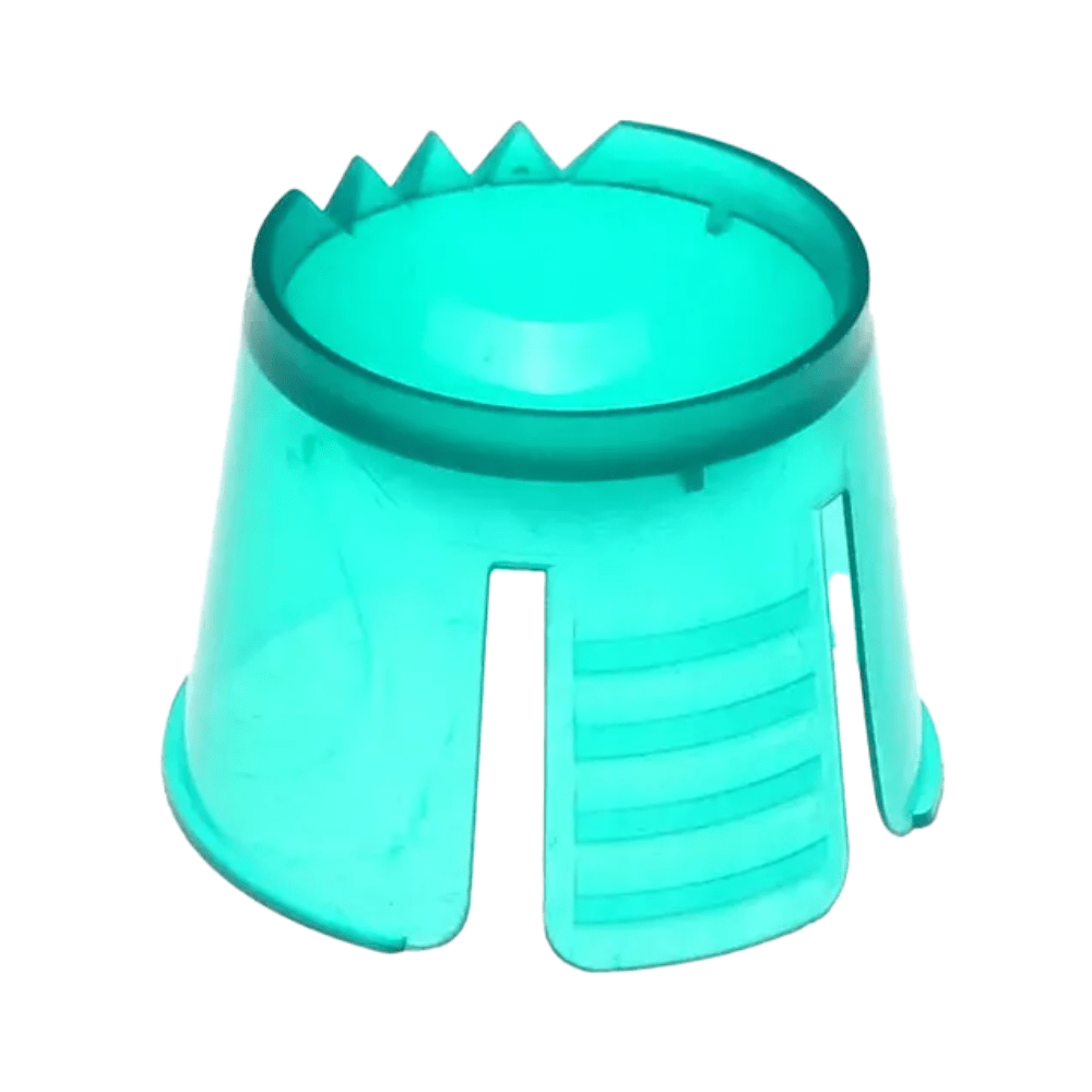 A turquoise sandcastle mold made of robust polypropylene has a cylindrical shape with an open top. It has a small serrated edge on one side and three vertical slots at the bottom. It resembles the AMPri PP disposable dappen dish used for portioning and mixing dental materials.