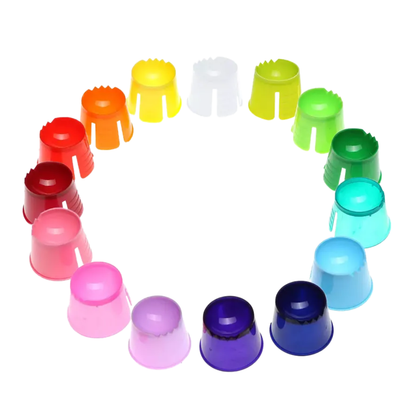 Displayed is a circular arrangement of colorful AMPri PP disposable dappen dish caps in shades of red, orange, yellow, white, green, blue, purple, and pink in a harmonious color gradient pattern against a bright white background.