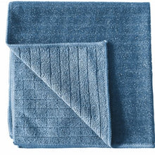 The Arcora Scrub & Clean 2N1 microfiber cloth (40 x 40 cm) from Arcora International GmbH is shown with a folded corner, revealing the ribbed underside; the smooth top and textured back are ideal for all surfaces.