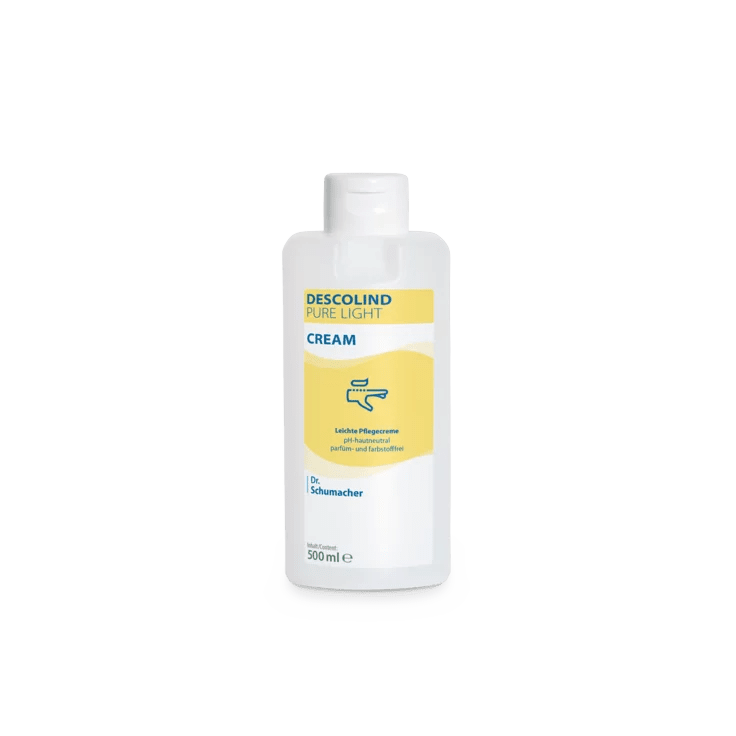A white 500 ml plastic bottle of Dr. Schumacher GmbH Descolind Pure Light Cream care cream, fragrance-free for sensitive skin, has a yellow label with blue lettering and is photographed against a plain white background.