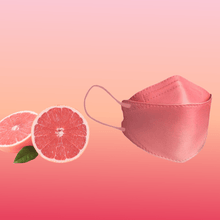 A particle-filtering Altruan designer face mask (FFP2 standard) is elegantly positioned next to two grapefruit halves on a pink gradient background, highlighting its stylish design and ergonomic fit.