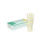 An internally coated quality examination glove by B. Braun Manufix® Sensitive is displayed upright next to its packaging box. The box is predominantly white with green and yellow accents and text. The glove, made from natural latex, is beige, smooth, and appears to be medium-sized – perfect for people with sensitive skin. The background is plain white.