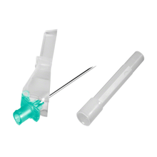 A B. Braun Sterican® Safety injection needle, featuring a blue-green plastic cover at one end and a transparent sleeve at the other, is positioned diagonally with a separate white cap next to it on a plain white background. This illustrates the safety mechanism of modern safety injection needles from B. Braun Deutschland GmbH & Co. KG.
