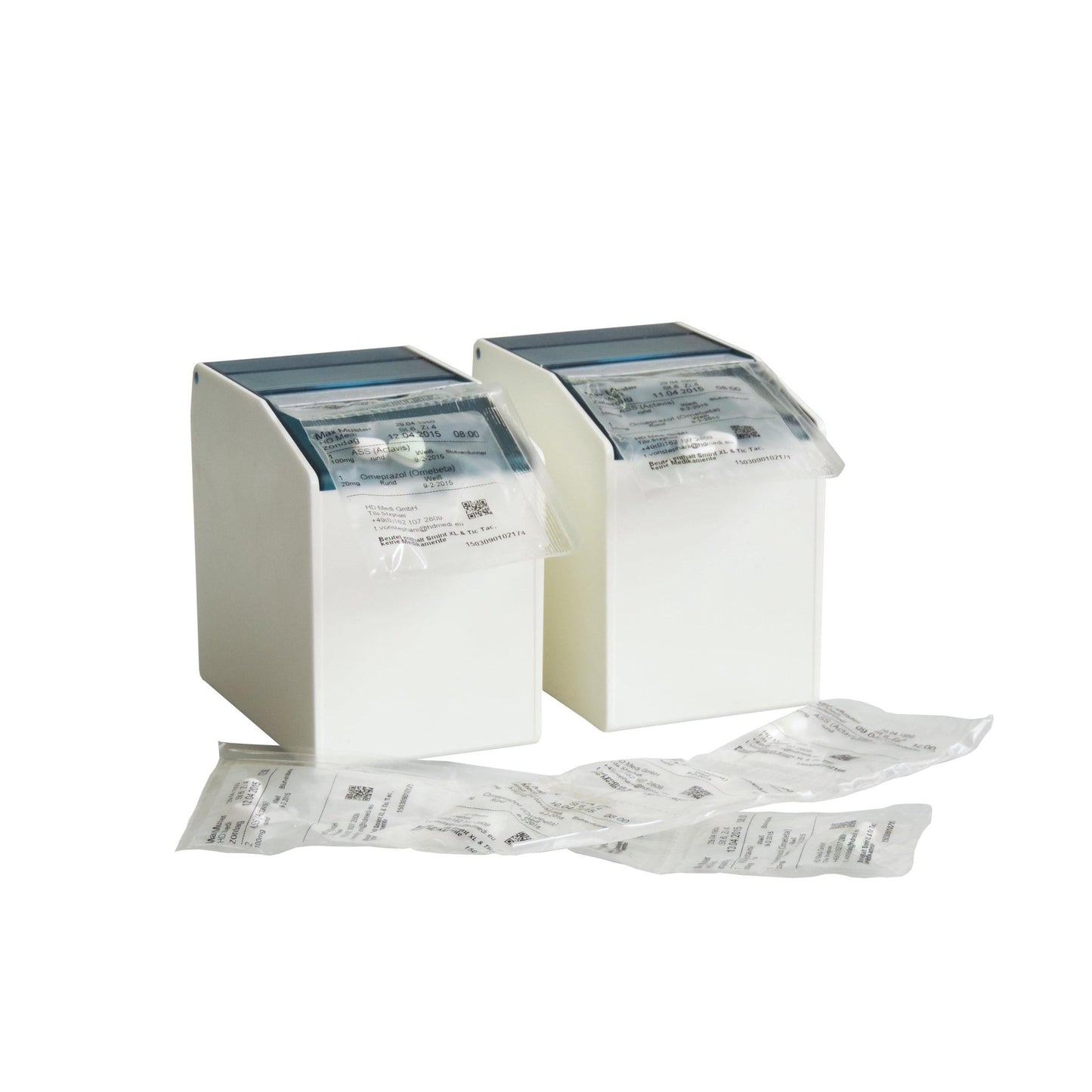Two white Novocal blister box dispensers (1 flexible front flap, 2 rear magnetic strips, 80 mm, 1 pack) hold sealed medication packages, with additional packs of small products on a white surface against a solid background.