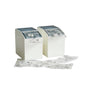 Two white Novocal blister box dispensers (1 flexible front flap, 2 rear magnetic strips, 80 mm, 1 pack) hold sealed medication packages, with additional packs of small products on a white surface against a solid background.