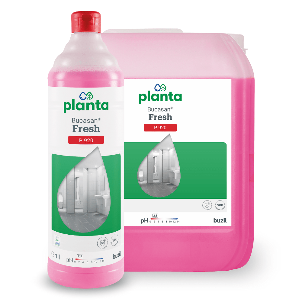 Displayed are a pink bottle and a container with Buzil Bucasan® Fresh P 920, an environmentally friendly, universal sanitary maintenance cleaner from BUZIL-WERK Wagner GmbH & Co. KG. Each item is labeled with a green-white label featuring a water droplet revealing a bathroom. This eco-friendly solution effectively removes mineral stains and has a pH value of 2.3.