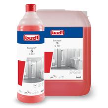 A red bottle and a larger red container, both with the logo of BUZIL-WERK Wagner GmbH & Co. KG and "Buzil Bucazid® S G 467 sanitary cleaner with odor blocker", show images of a bathroom with a toilet and sink. This powerful cleaner uses amidosulfonic acid for enhanced cleaning performance. The bottle contains 1 liter, while the container is larger.